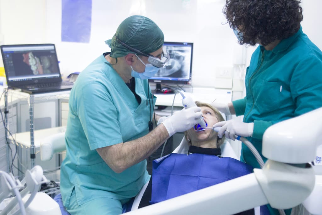 Dentists performing a dental examination on a patient